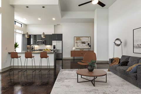 a living room with a kitchen and a couch and a table